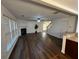 Open-concept living room showcasing hardwood floors, a cozy fireplace, and a staircase leading to the upper level at 3613 Tinsley Sw Way, Atlanta, GA 30331