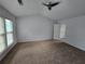 Generous main bedroom featuring plush carpet, ample natural light, and a convenient walk-in closet at 3613 Tinsley Sw Way, Atlanta, GA 30331