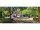 Community playground with colorful equipment surrounded by lush greenery and trees at 3613 Tinsley Sw Way, Atlanta, GA 30331