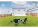 Backyard with patio, green grass and a fire pit with seating, great for entertaining guests at 3993 Makeover Ct, South Fulton, GA 30349