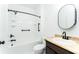 Bright bathroom with a tub-shower combo, white subway tile, and sleek black hardware at 3993 Makeover Ct, South Fulton, GA 30349