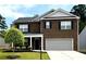 Charming two-story brick home with a well-manicured lawn and a two-car garage at 3993 Makeover Ct, South Fulton, GA 30349