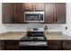 Close-up of a stylish kitchen with stainless steel appliances and granite countertops at 3993 Makeover Ct, South Fulton, GA 30349
