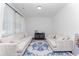Bright living room with hardwood floors, two sofas, and a large blue rug at 3993 Makeover Ct, South Fulton, GA 30349