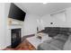 Comfortable living room featuring a fireplace, large TV, and a sectional sofa at 3993 Makeover Ct, South Fulton, GA 30349