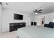 Large primary bedroom featuring a TV, ceiling fan, neutral color scheme, and dark furnishings at 3993 Makeover Ct, South Fulton, GA 30349