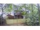 Backyard featuring a wooden fence, trees and view of a second story deck at 1104 Huntington Se Trce, Smyrna, GA 30082