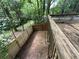 View of fenced backyard from elevated deck; natural tree line at 1104 Huntington Se Trce, Smyrna, GA 30082