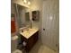 Cozy bathroom with a white sink on a brown vanity, a large mirror, and a toilet at 1104 Huntington Se Trce, Smyrna, GA 30082