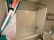 A bathroom with white tile, a shower/tub combo, a toilet, and a colorful shower curtain at 1104 Huntington Se Trce, Smyrna, GA 30082