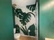Nicely decorated half bathroom with a tropical leaf mural on the walls and wood flooring at 1104 Huntington Se Trce, Smyrna, GA 30082