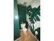 Unique half bathroom showcasing a tropical leaf mural accent wall and modern fixtures at 1104 Huntington Se Trce, Smyrna, GA 30082