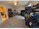 A bedroom with beige carpet, a ceiling fan, and many storage racks at 1104 Huntington Se Trce, Smyrna, GA 30082