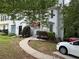 Charming two-story townhome with red awning over the front door and well-maintained landscaping at 1104 Huntington Se Trce, Smyrna, GA 30082