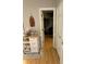 Hallway view with rolling cart and access to closet and bathroom with tropical themed art at 1104 Huntington Se Trce, Smyrna, GA 30082