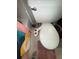 A view of a white toilet with a bidet attachment, a tile floor, and a colorful shower curtain at 1104 Huntington Se Trce, Smyrna, GA 30082