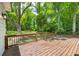 Spacious back deck overlooks a green, lush, and wooded backyard area at 159 S Forest S Ave, Social Circle, GA 30025