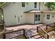 Stairway leading to a spacious wooden backyard deck with black metal railings at 159 S Forest S Ave, Social Circle, GA 30025