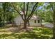 Backyard with mature tree provides shade to a two-story home with a back deck at 159 S Forest S Ave, Social Circle, GA 30025