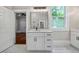Bathroom featuring a white vanity with drawers, a large mirror, and a view to another room at 159 S Forest S Ave, Social Circle, GA 30025