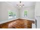 Spacious bedroom featuring hardwood floors, two windows and trim at 159 S Forest S Ave, Social Circle, GA 30025