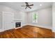 A bedroom featuring a fireplace, hardwood floors, and natural light at 159 S Forest S Ave, Social Circle, GA 30025