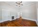 Bedroom featuring fireplace, hardwood floors, and a ceiling fan at 159 S Forest S Ave, Social Circle, GA 30025