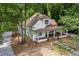 Charming home with covered porch, stone walkway, beautiful landscaping, and mature shade trees at 159 S Forest S Ave, Social Circle, GA 30025