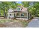 Inviting two-story home with a spacious wrap-around porch and nicely landscaped yard at 159 S Forest S Ave, Social Circle, GA 30025