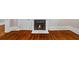 Close-up of a fireplace, hardwood floors, and white trim at 159 S Forest S Ave, Social Circle, GA 30025