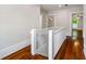 A hallway with wood floors and white trim leads to several bedrooms at 159 S Forest S Ave, Social Circle, GA 30025