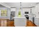 Bright kitchen featuring stainless steel appliances, a central island, and white cabinets at 159 S Forest S Ave, Social Circle, GA 30025