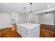 Open kitchen featuring a central island, modern pendant lighting, and stainless steel appliances at 159 S Forest S Ave, Social Circle, GA 30025