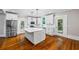 Open kitchen with a central island, stainless steel appliances, and white cabinets at 159 S Forest S Ave, Social Circle, GA 30025