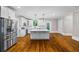 Bright kitchen with a central island, stainless steel appliances, and white cabinets at 159 S Forest S Ave, Social Circle, GA 30025