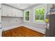 Laundry room with hardwood floors, storage cabinets, and large windows overlooking a green backyard at 159 S Forest S Ave, Social Circle, GA 30025