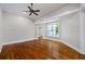 Bright living room with hardwood floors, a ceiling fan, and access to additional rooms at 159 S Forest S Ave, Social Circle, GA 30025