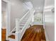 Staircase with wooden steps, white risers, and handrail at 159 S Forest S Ave, Social Circle, GA 30025