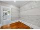 Spacious walk-in closet with wire shelving and hardwood floors connecting to a nearby bathroom at 159 S Forest S Ave, Social Circle, GA 30025
