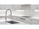 Bright kitchen featuring white cabinets, quartz countertops, and a modern faucet at 2520 Peachtree Nw Rd # 403, Atlanta, GA 30305