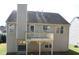 View of a house back exterior with a deck, chimney, siding, a door and some windows at 2918 Egret Ln, Austell, GA 30106