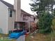Rear exterior view of townhouse featuring backyard with deck at 2918 Egret Ln, Austell, GA 30106