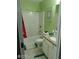 A bright bathroom with green walls, a shower-tub combo, and a granite countertop at 2918 Egret Ln, Austell, GA 30106