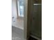 A bathroom with a large window, bathtub, and walk-in shower at 2918 Egret Ln, Austell, GA 30106