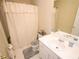 Bright bathroom featuring a shower with a curtain, white vanity, and neutral tile at 2918 Egret Ln, Austell, GA 30106