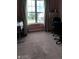 Neutral bedroom featuring carpeted floors, large window with curtains, and space for office and storage at 2918 Egret Ln, Austell, GA 30106