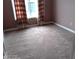 Bedroom featuring tan carpet and natural light from a window at 2918 Egret Ln, Austell, GA 30106