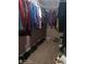 Walk-in closet with hanging clothes, shoes lined up on the floor, and storage boxes at 2918 Egret Ln, Austell, GA 30106