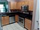 Well-equipped kitchen featuring stainless steel appliances, sleek black countertops, and light wood cabinetry at 2918 Egret Ln, Austell, GA 30106