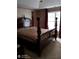 Main bedroom showcasing an ornate four-poster bed, and a window with draperies at 2918 Egret Ln, Austell, GA 30106